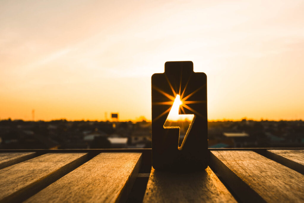 Battery with a lightning bolt symbol at sunset