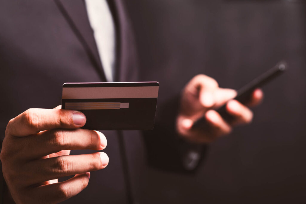 Person using a credit card and smartphone for digital banking