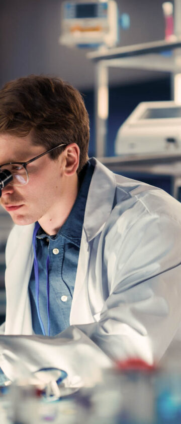 Medical research scientists working with a microscope in a laboratory