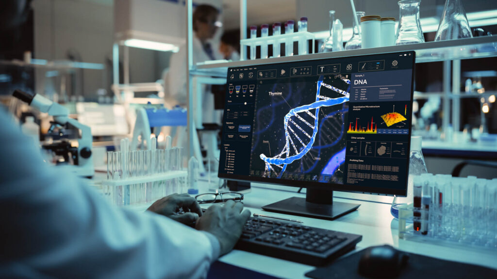 Medical research scientist reviewing genetic data and DNA analysis on a computer screen